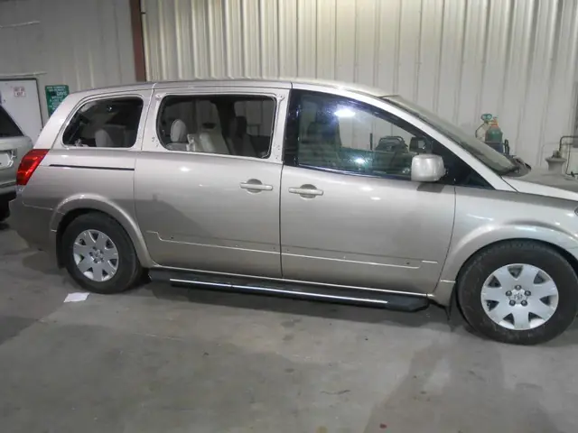 The finished gold Nissan Quest, the repaired doors matching the panels either side of them